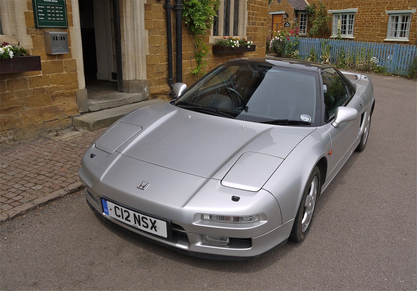 Silver coupe with pop-up headlights and aerodynamic front design