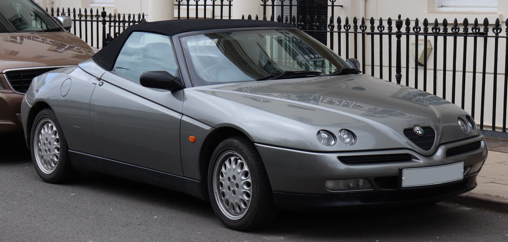 Convertible sports car with quad round headlights and alloy wheels