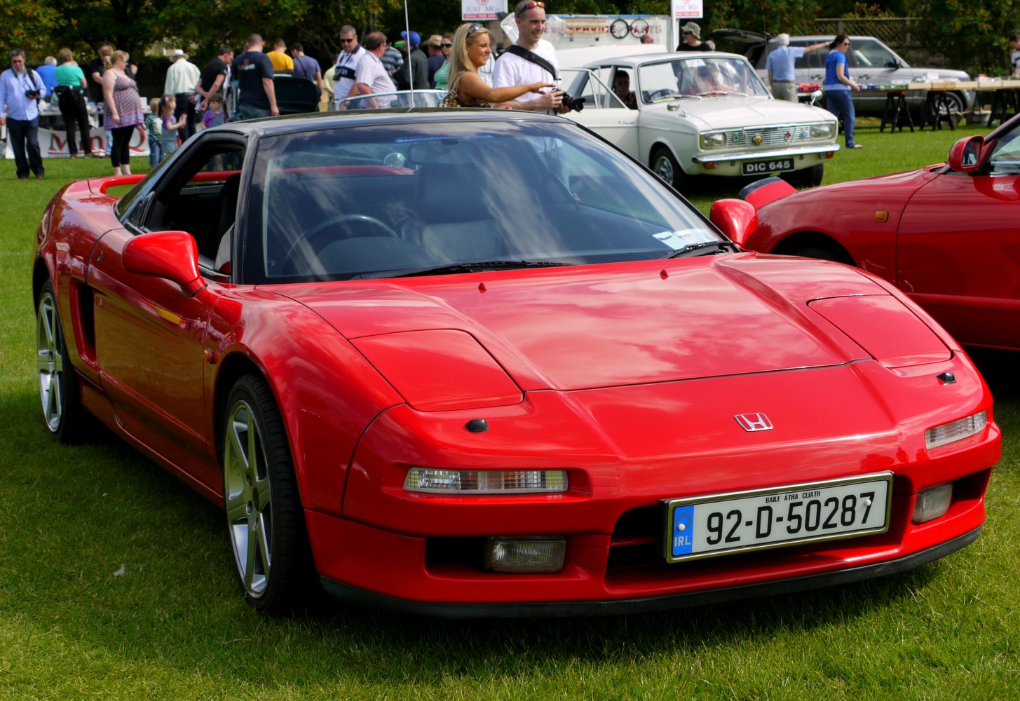 Red vintage sports coupe with pop-up headlights