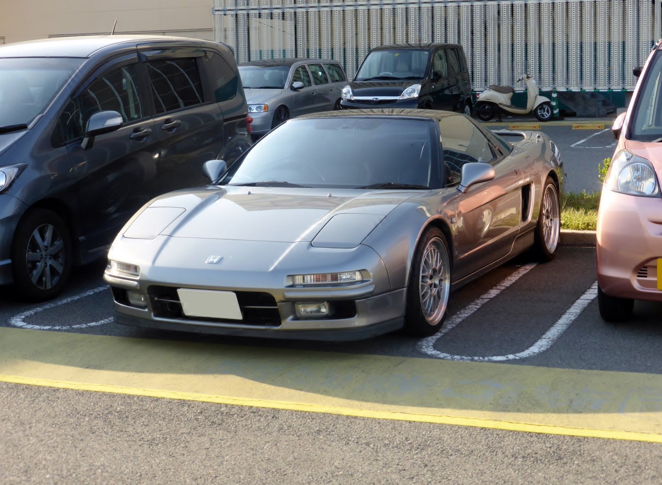 Front view of a vintage sports coupe with pop-up headlights and sleek body lines