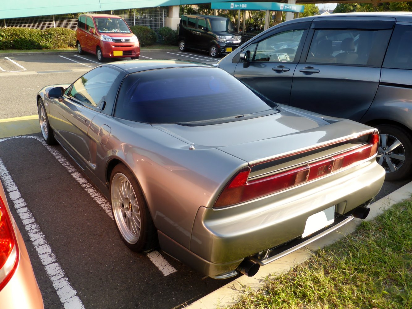 Rear and side view of a 1990s sports coupe with tinted rear windows and alloy wheels