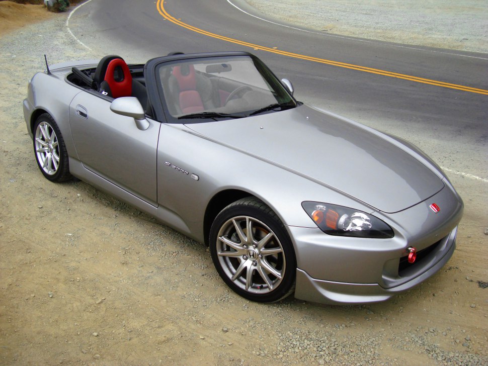 Silver convertible with red sport seats and alloy wheels parked roadside