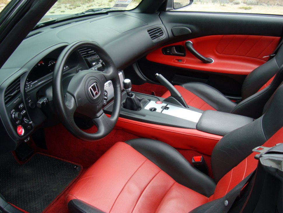 Red and black leather seats with manual transmission and sport steering wheel