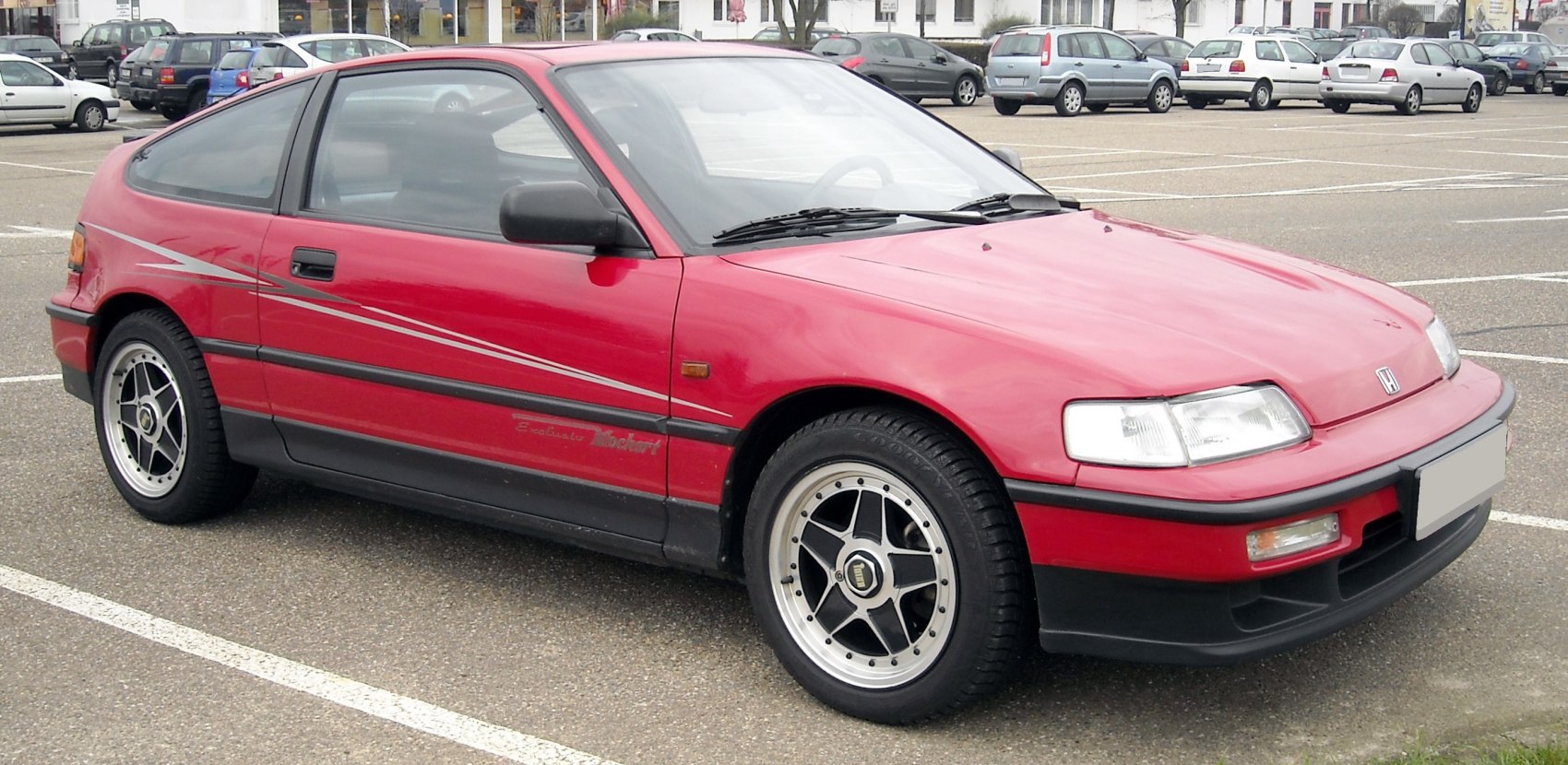 Red sporty hatchback with aerodynamic design and custom alloy wheels