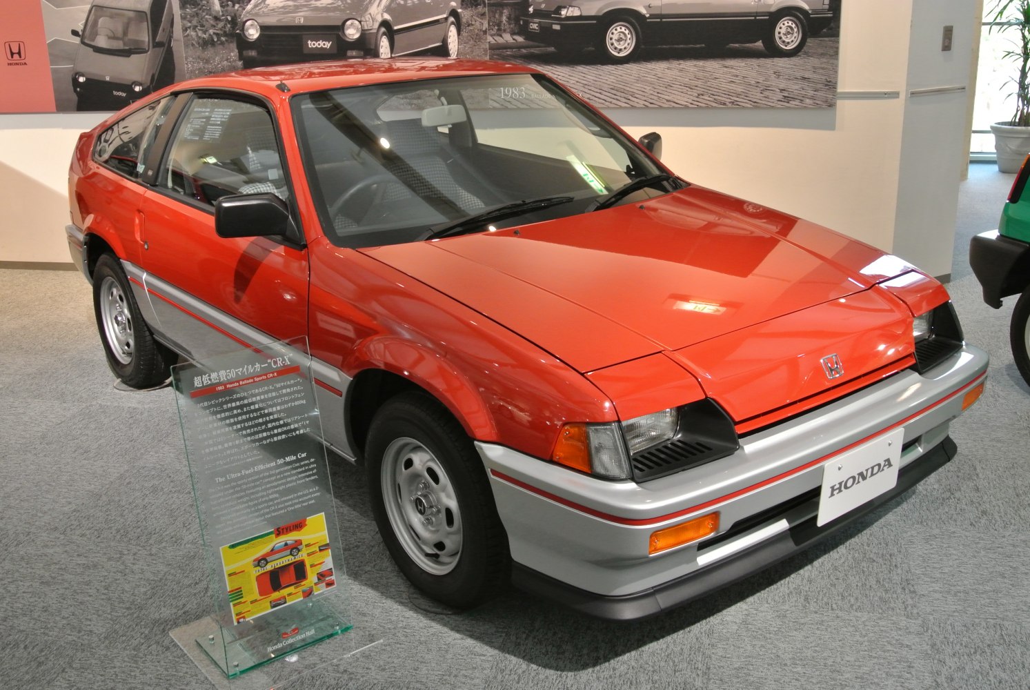 Red hatchback with pop-up headlights and two-tone paint