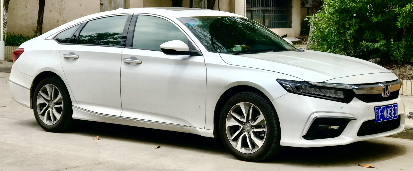 White sedan with LED headlights and alloy wheels