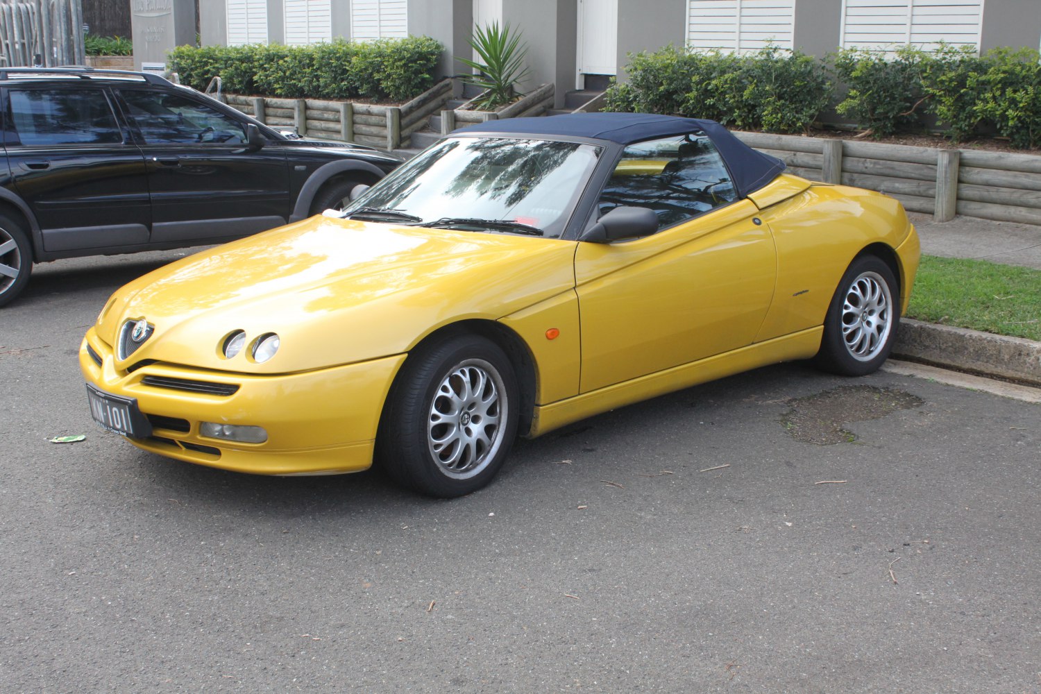 Yellow convertible with round headlights and alloy wheels