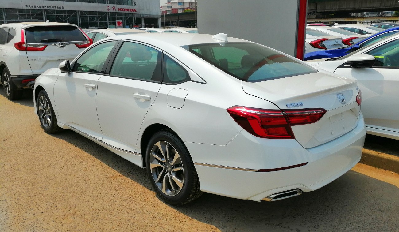 White sedan with LED tail lights and alloy wheels from rear-side angle