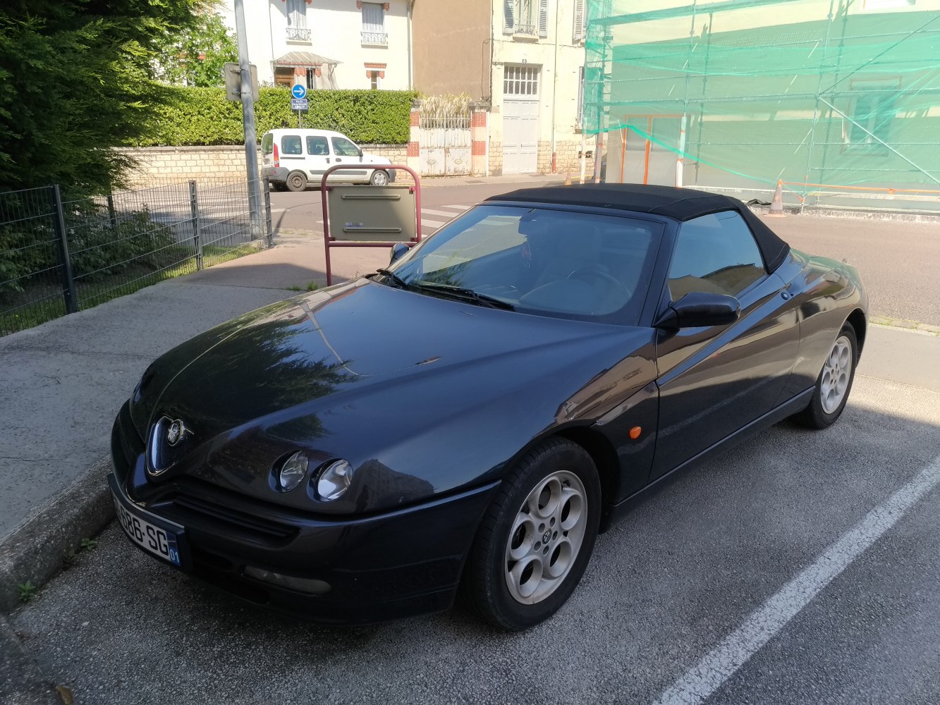 Convertible sports car front and side view with round headlights and soft top roof