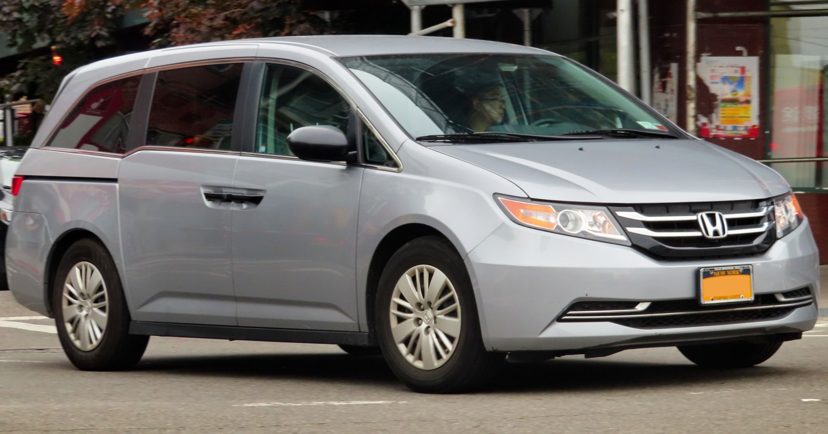 Silver minivan with modern headlights and a distinctive front grille