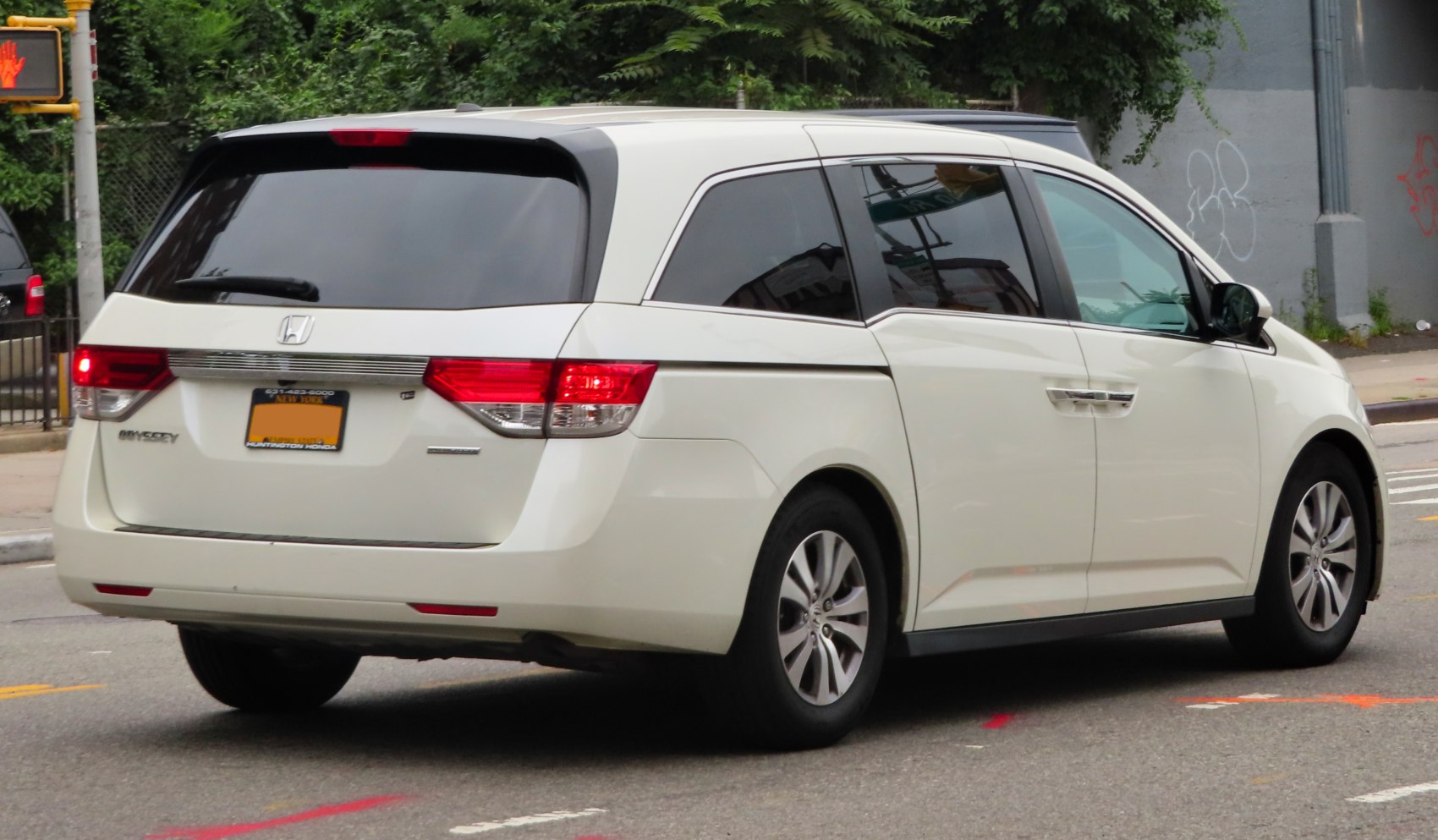 Rear view of a facelifted minivan with distinctive taillights and tinted rear windows