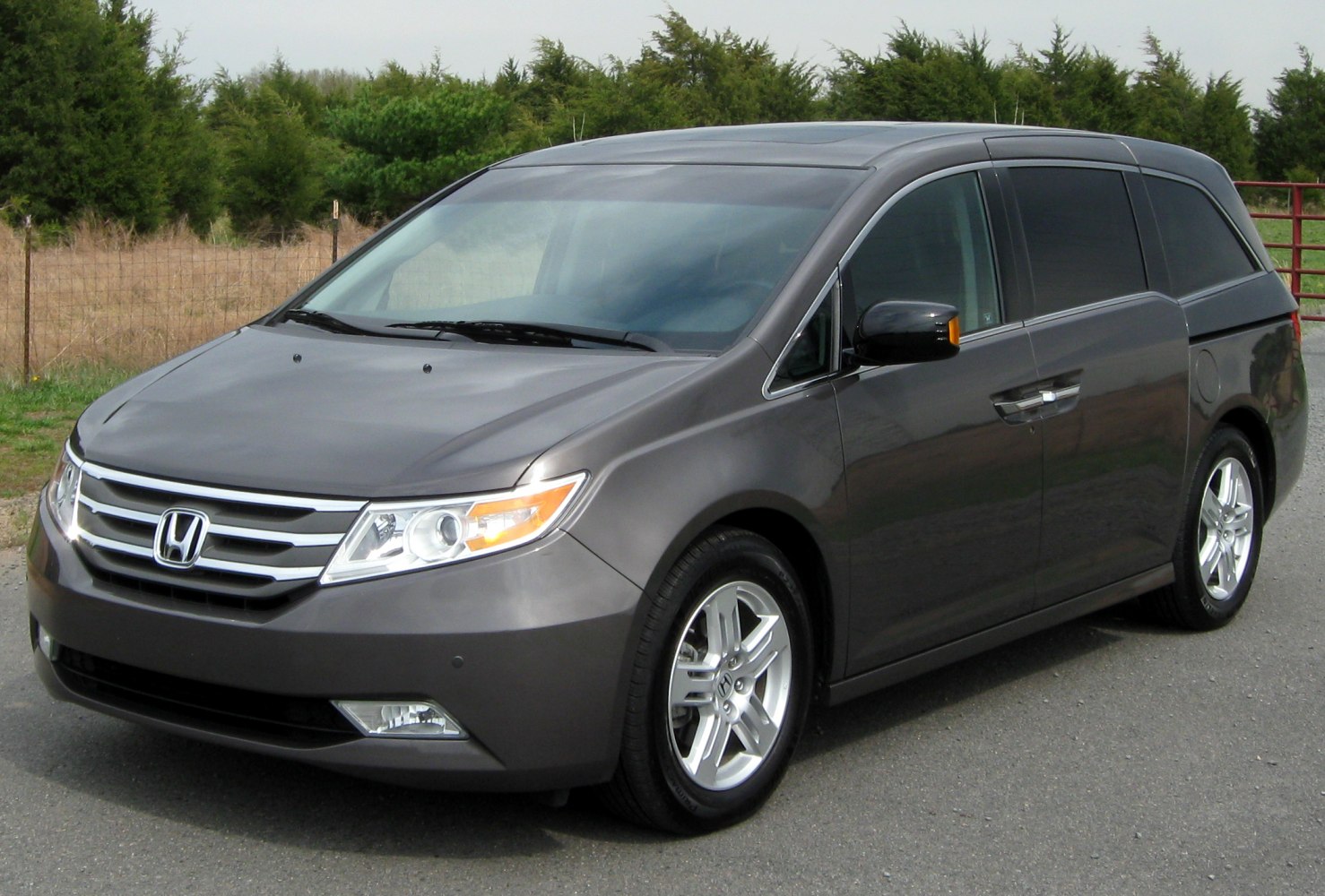 Front-side view of minivan with chrome grille and alloy wheels