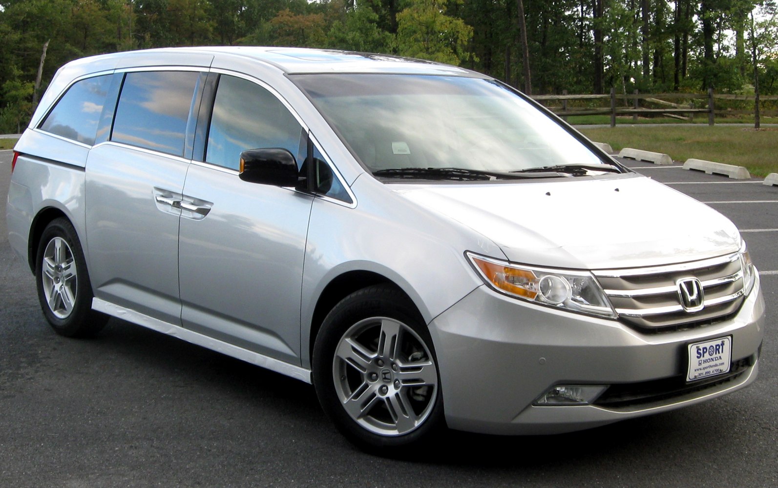 Silver minivan front side view with alloy wheels