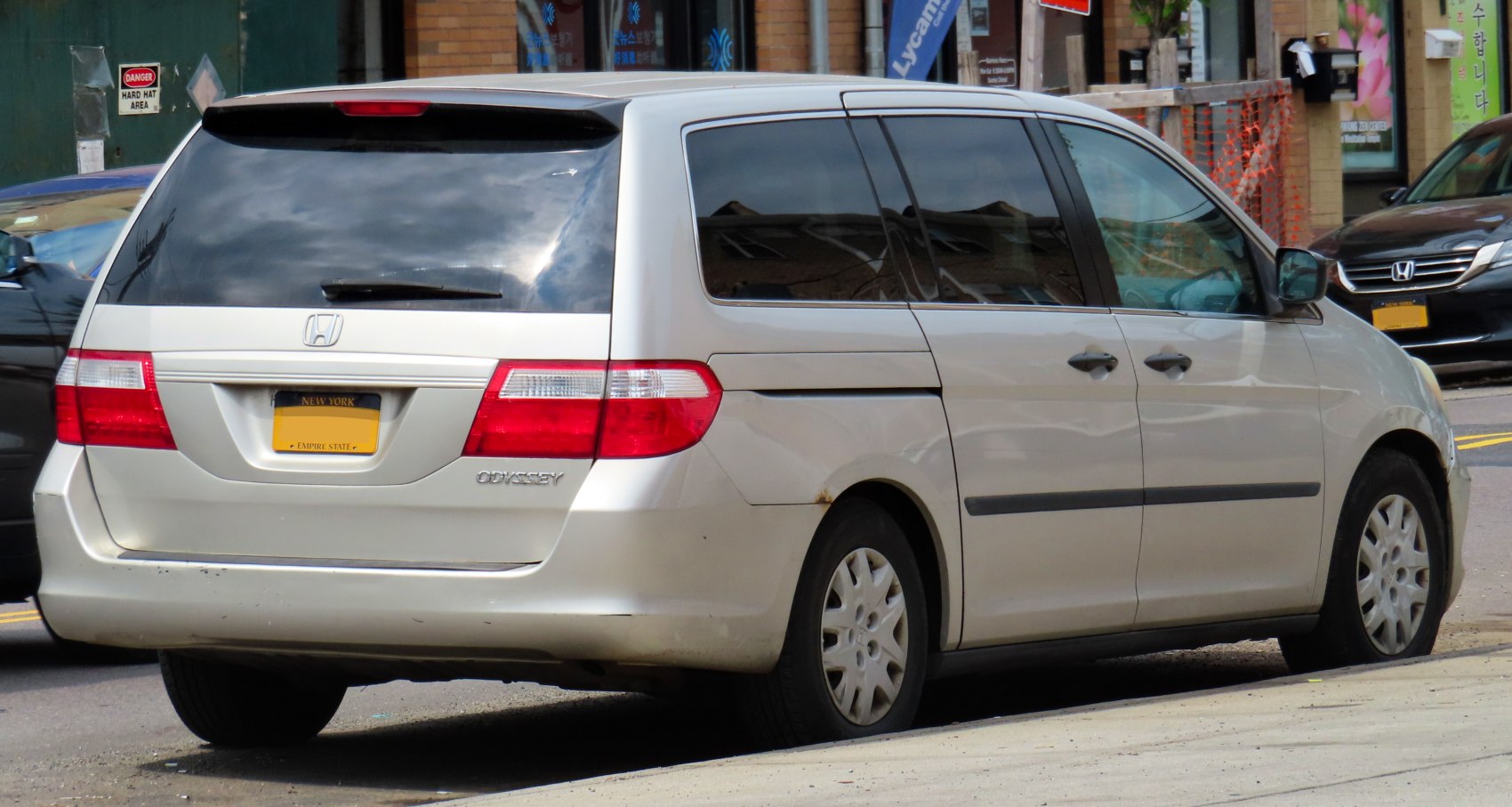 Silver minivan rear and side view showing sliding doors and rear windshield wiper