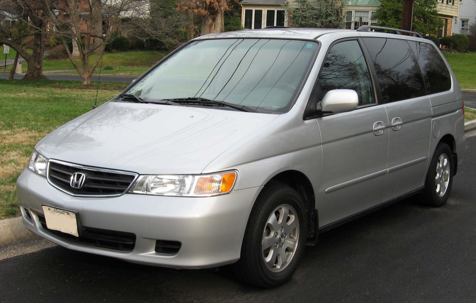 Silver minivan with sliding doors and alloy wheels parked on street