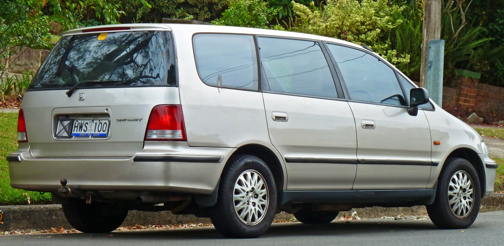 Rear side view of a 1995 minivan with distinctive window lines and tail lights