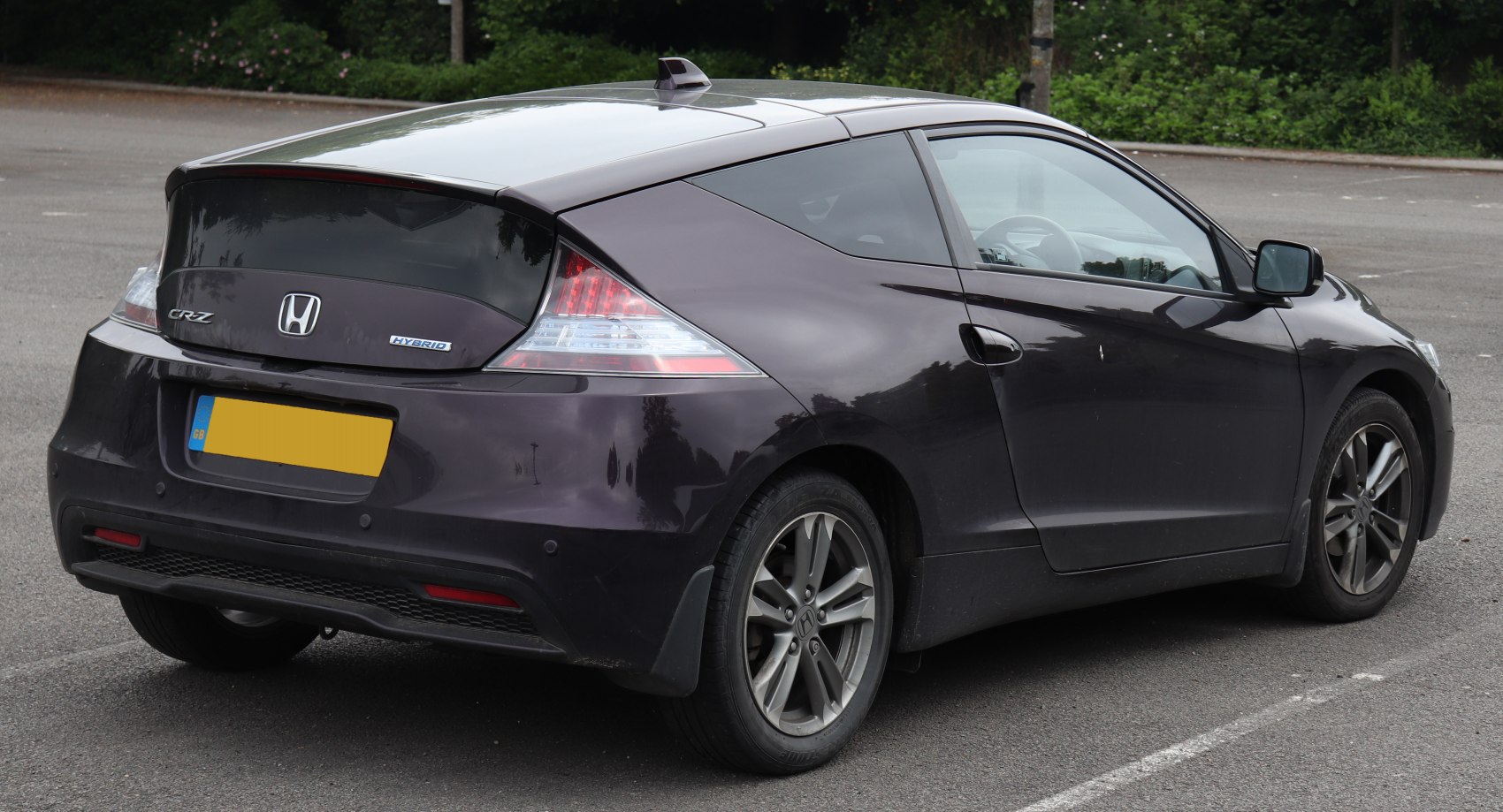 Rear side view of sporty hybrid with angular tail lights and alloy wheels