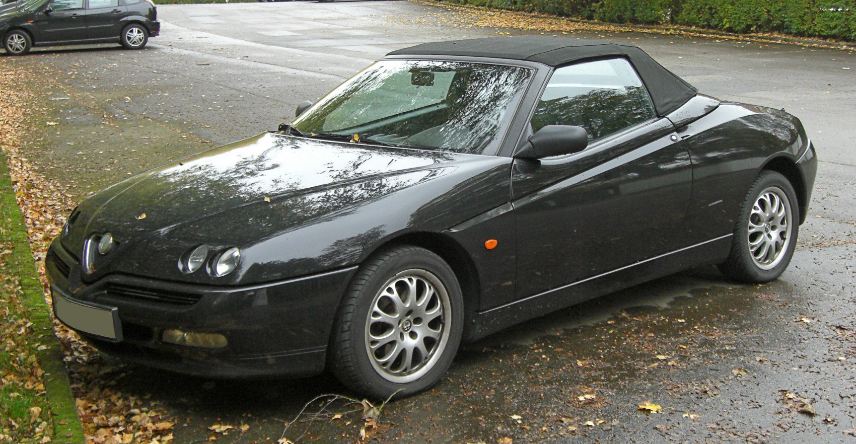 Black convertible with quad front headlights and aerodynamic design