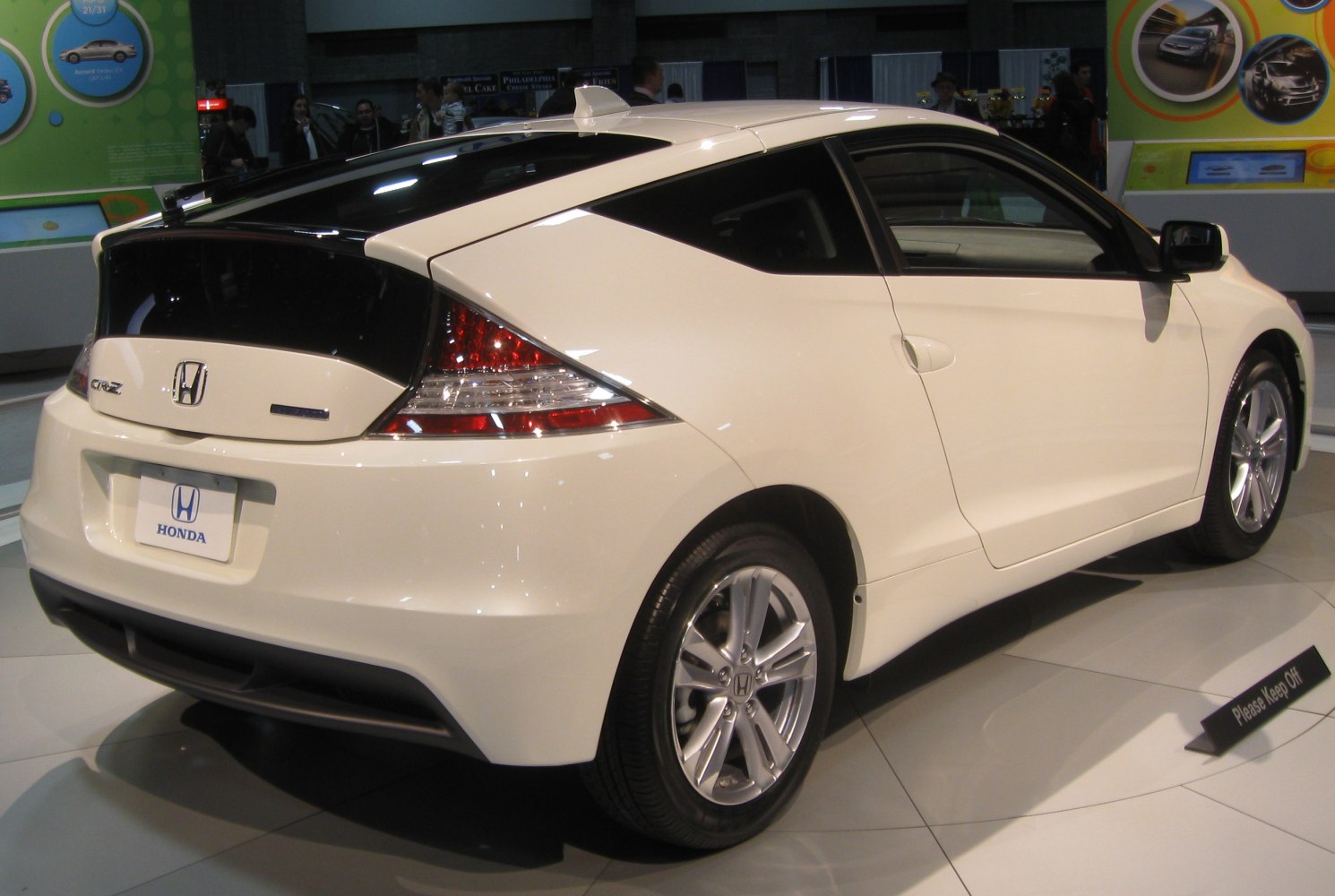 Rear side view of compact hybrid coupe with unique aerodynamic shape and taillight design