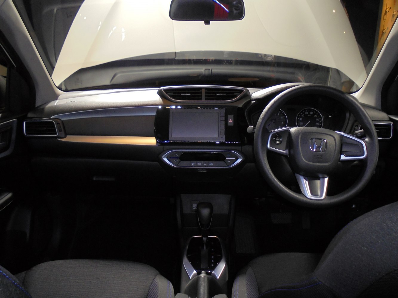 Modern car dashboard and steering wheel with touchscreen and automatic gear shift
