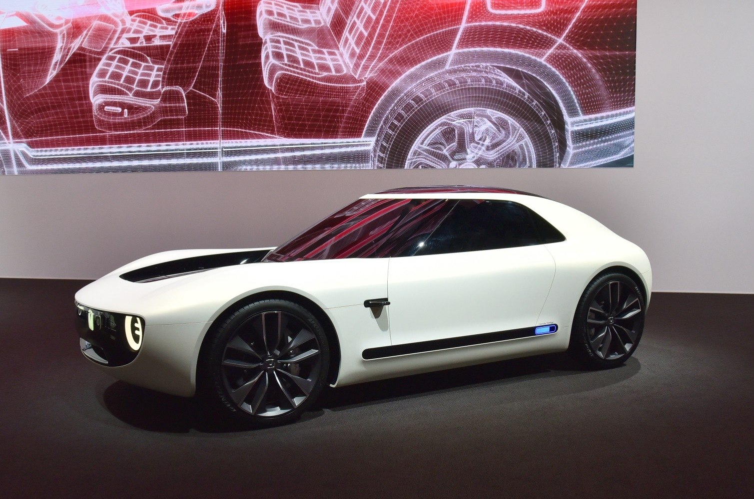 Sleek retro-modern electric sports car with unique headlights and aerodynamic body.