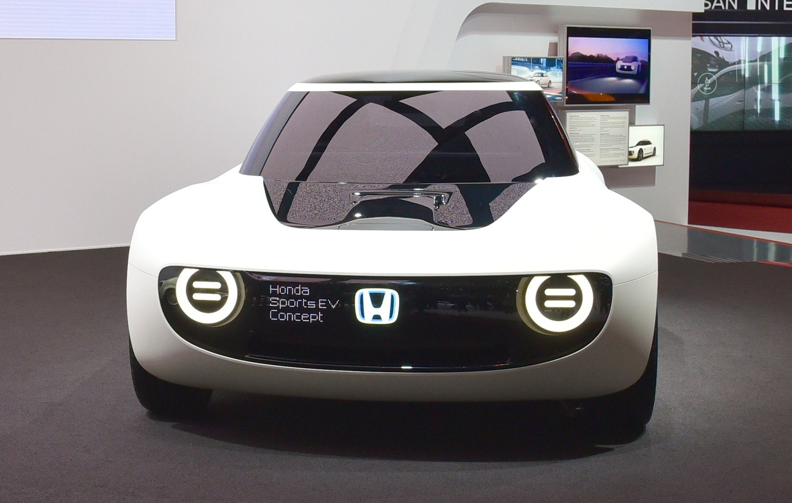 Futuristic front with circular LED headlights and sleek windshield