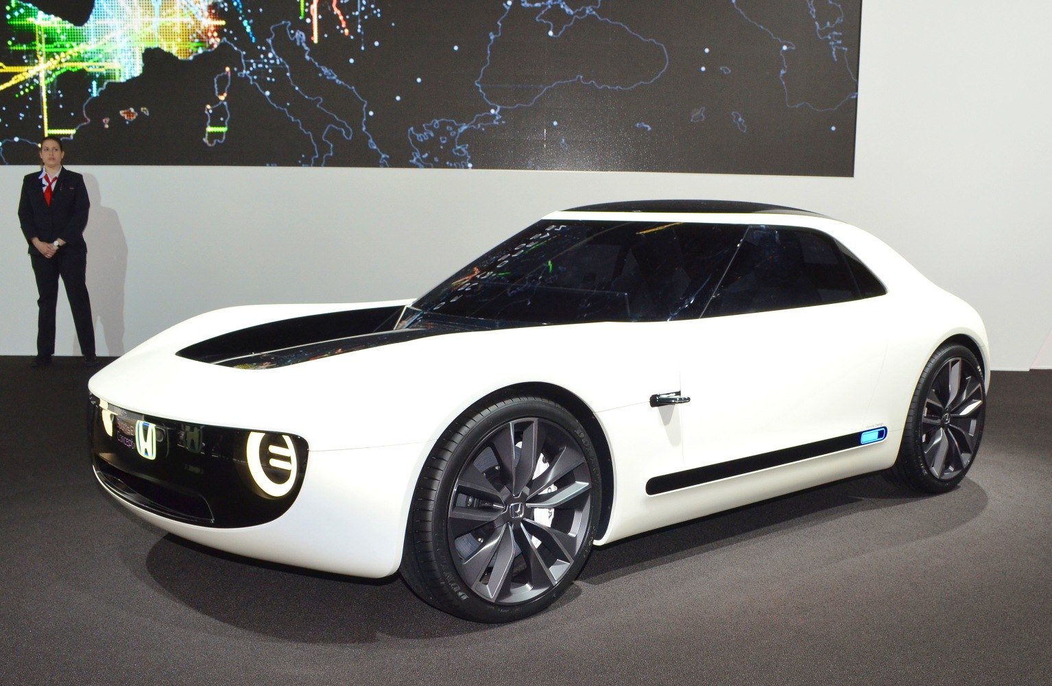 Electric coupe with circular LED headlights and large alloy wheels