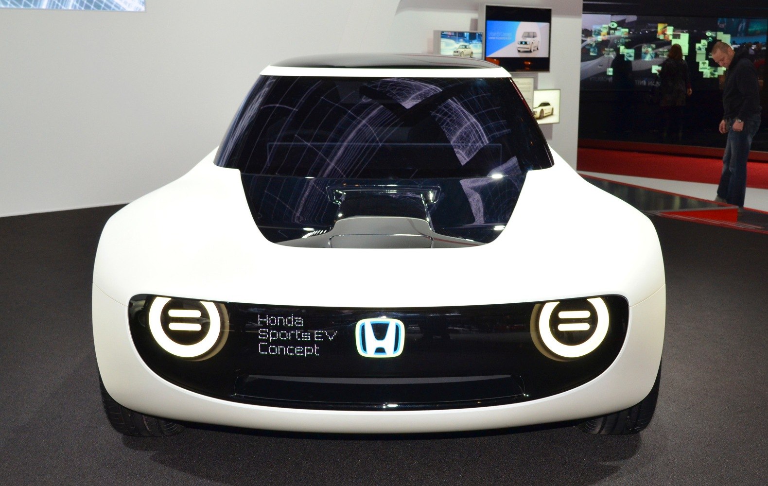 Front end with circular LED headlights and glossy black panel