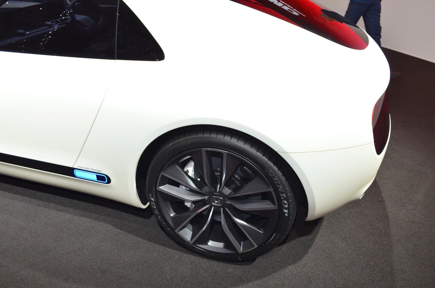Close-up of rear alloy wheel and smooth rear quarter panel.