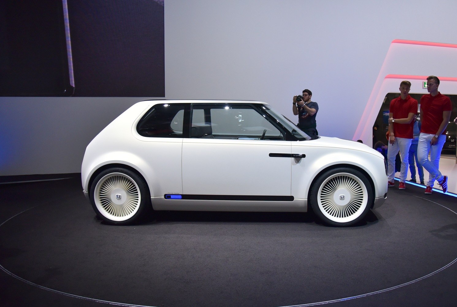 Side profile of compact car with unique aerodynamic wheel covers