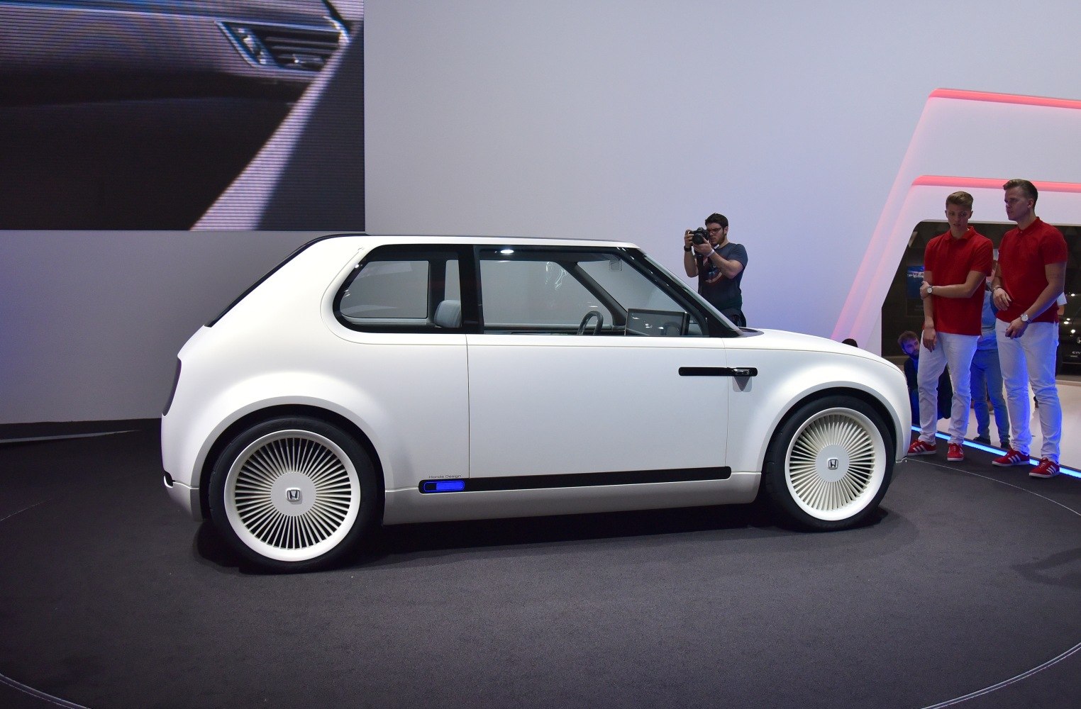 Compact electric vehicle with sleek retro design and futuristic wheels