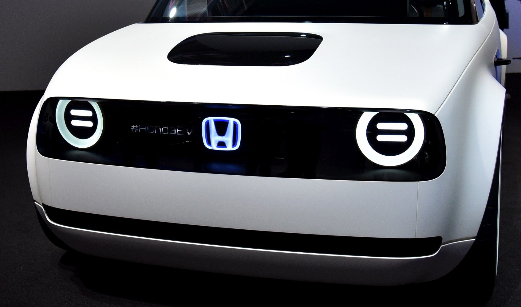 Round LED headlights and minimalist front fascia with illuminated logo