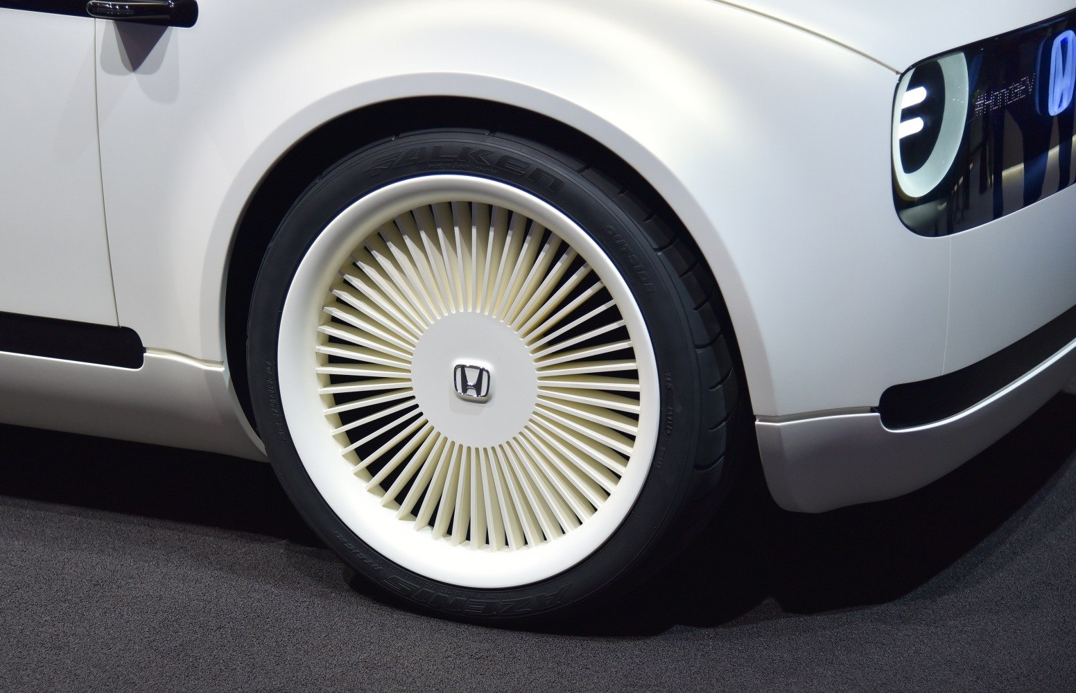 Close-up of futuristic wheel rim and LED headlight elements