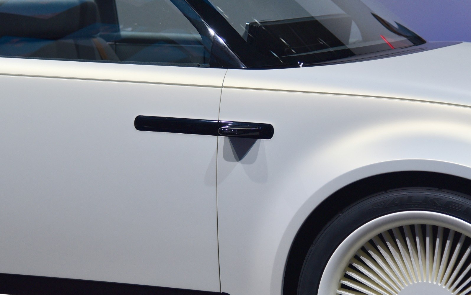 Close-up of futuristic door handle and spoked wheel design