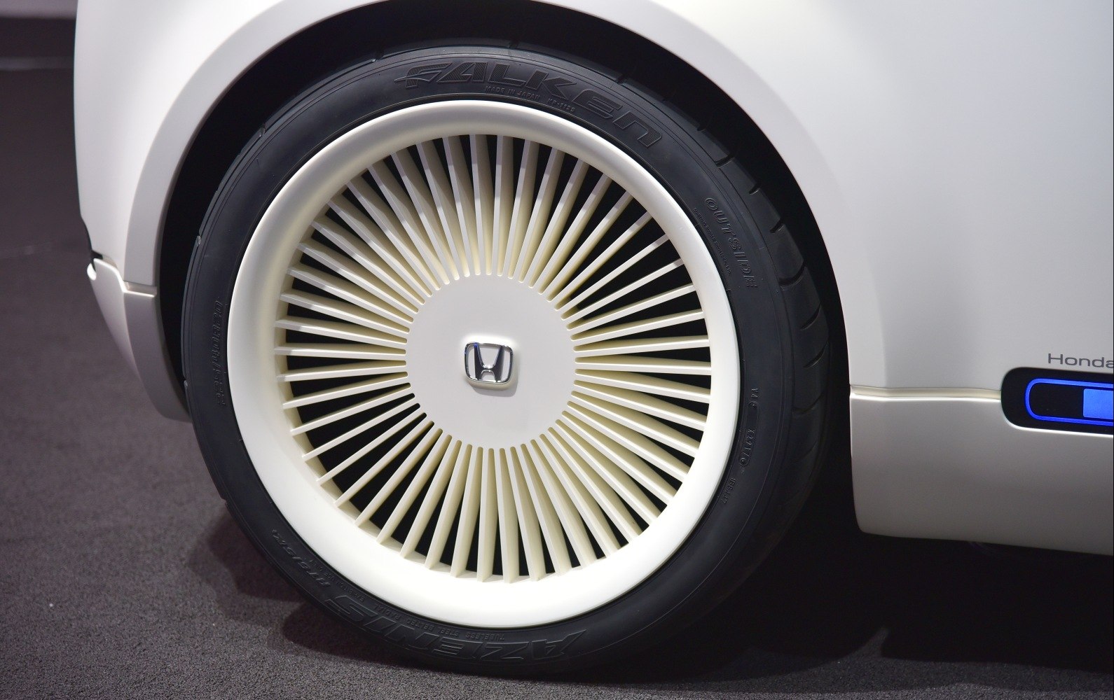 Close-up of aerodynamic wheel with Honda logo and detailed tire