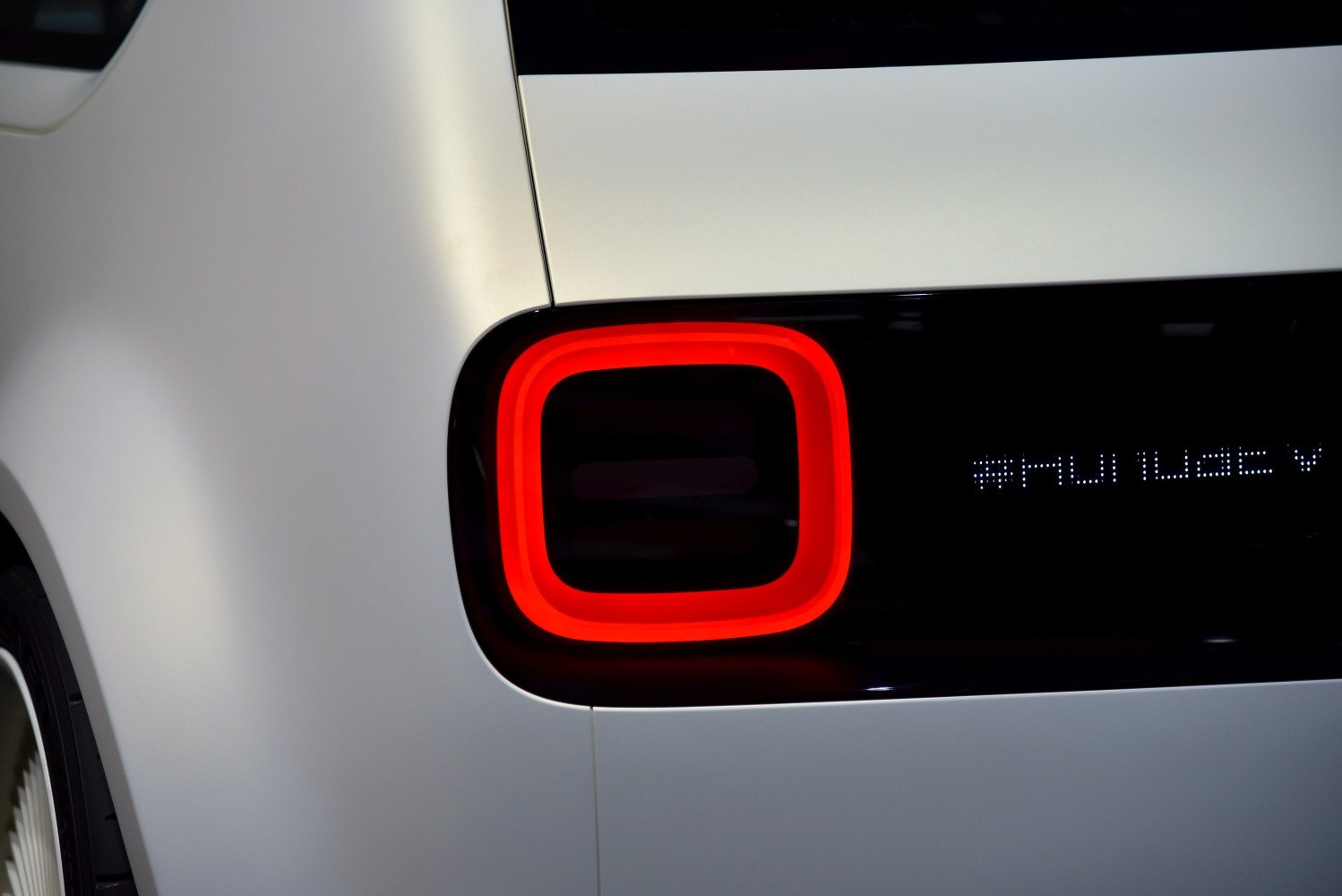 Rounded square LED rear light on electric vehicle