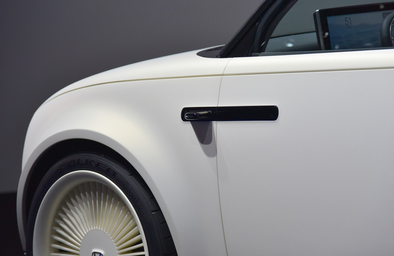 Futuristic black door handle and distinctive spoke wheel rim