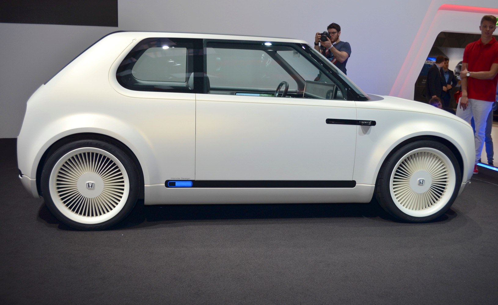 Side profile with futuristic wheel covers and minimalist design.