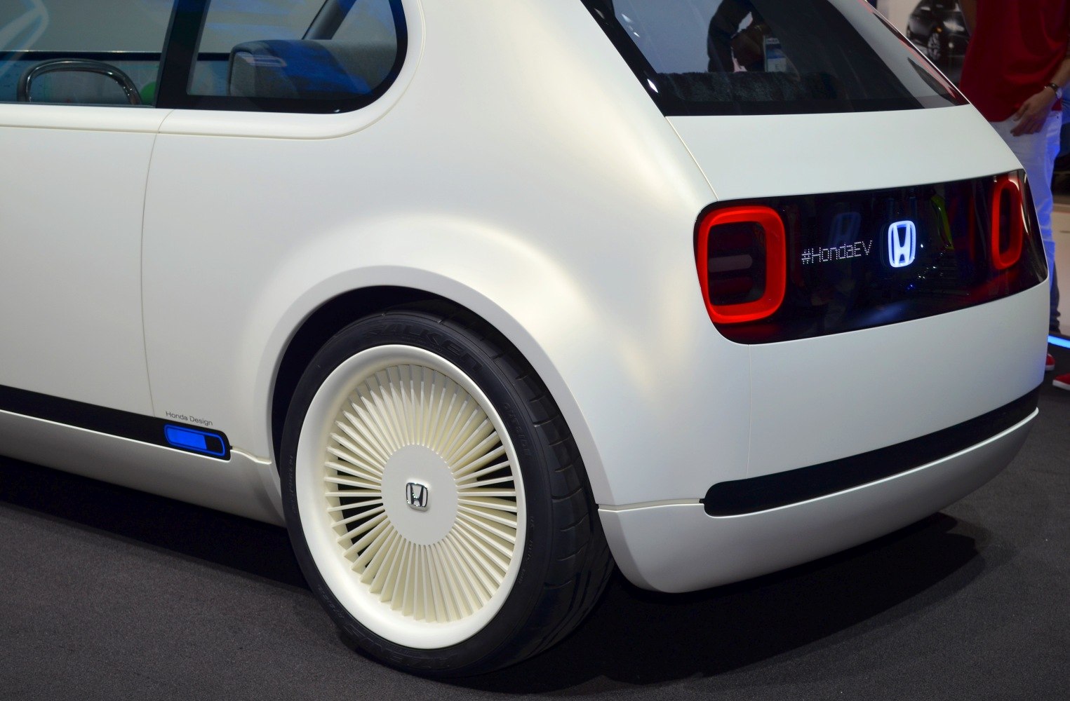 Rear view with LED tail lights and unique, finned wheel cover design.