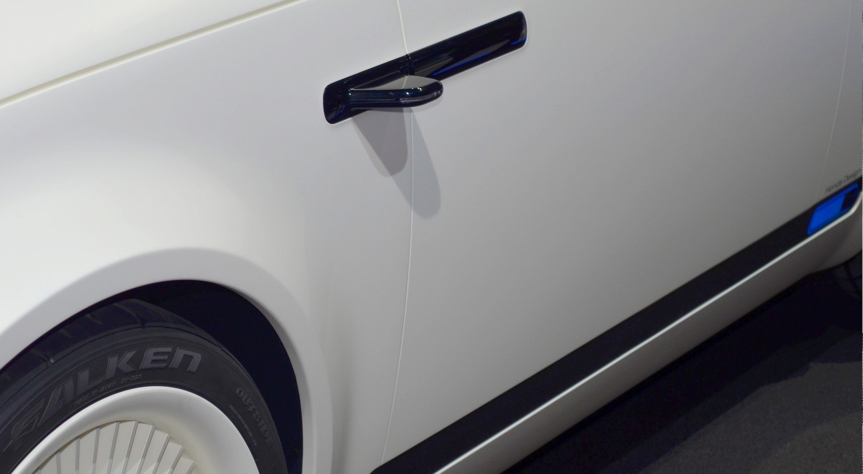 Side door with black handle and mirror in modern electric vehicle design