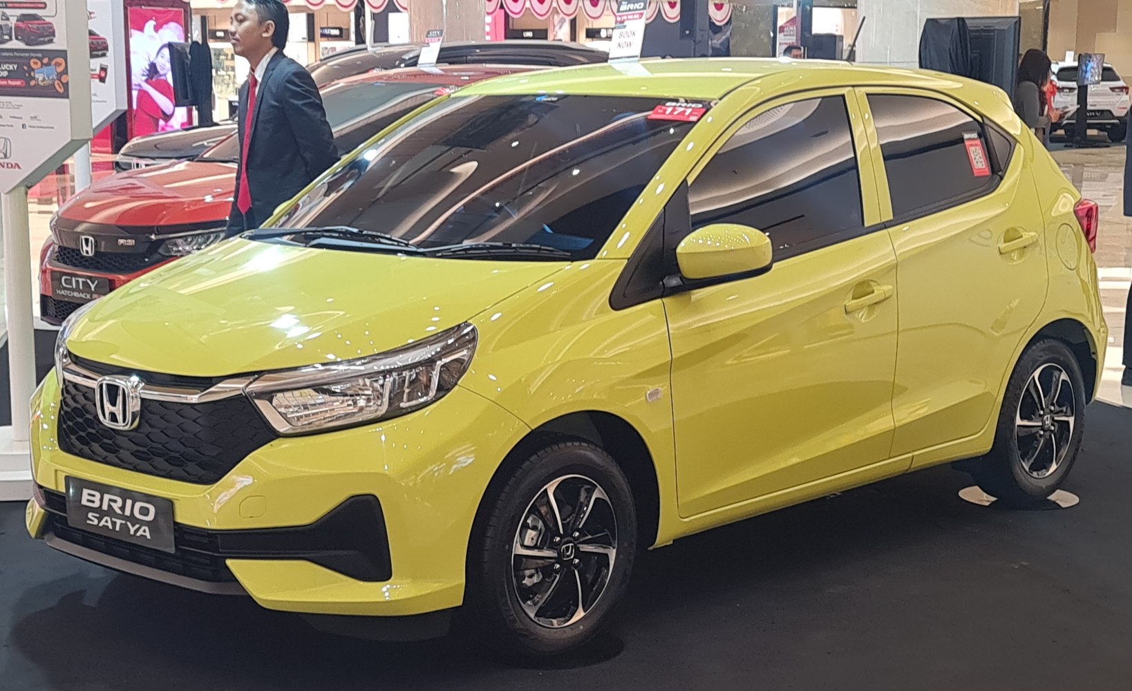 Yellow hatchback with modern headlights and sporty alloy wheels