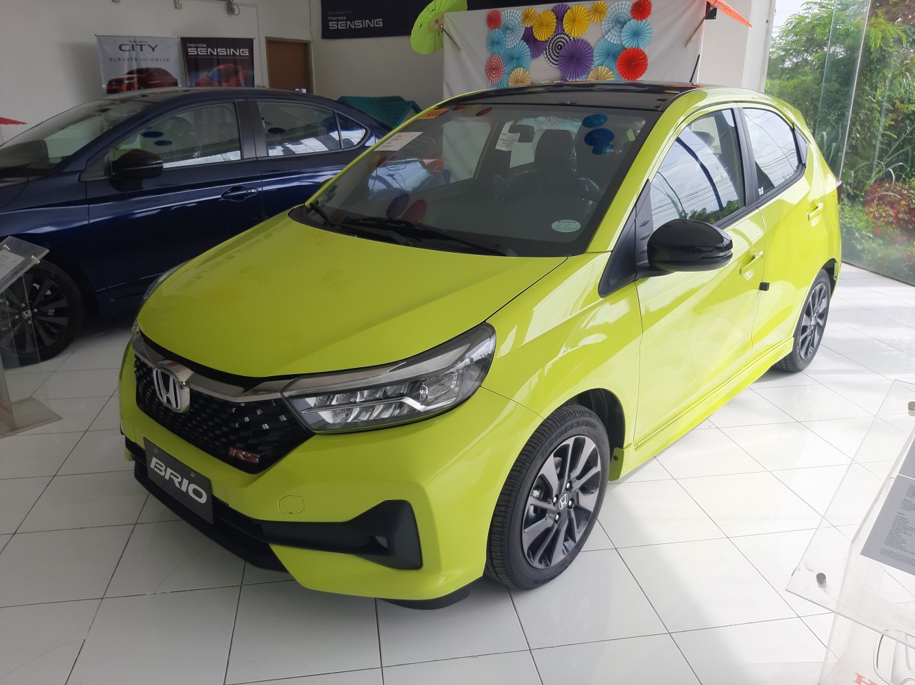 Bright lime green hatchback with LED headlights and sporty wheels