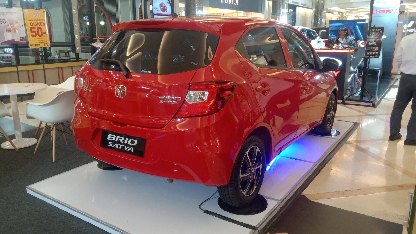Rear view of a red compact hatchback with alloy wheels