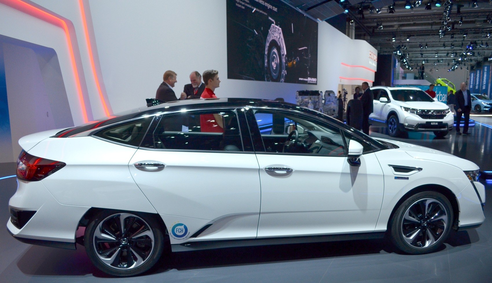 Side profile view of a sedan with aerodynamic design and modern wheels