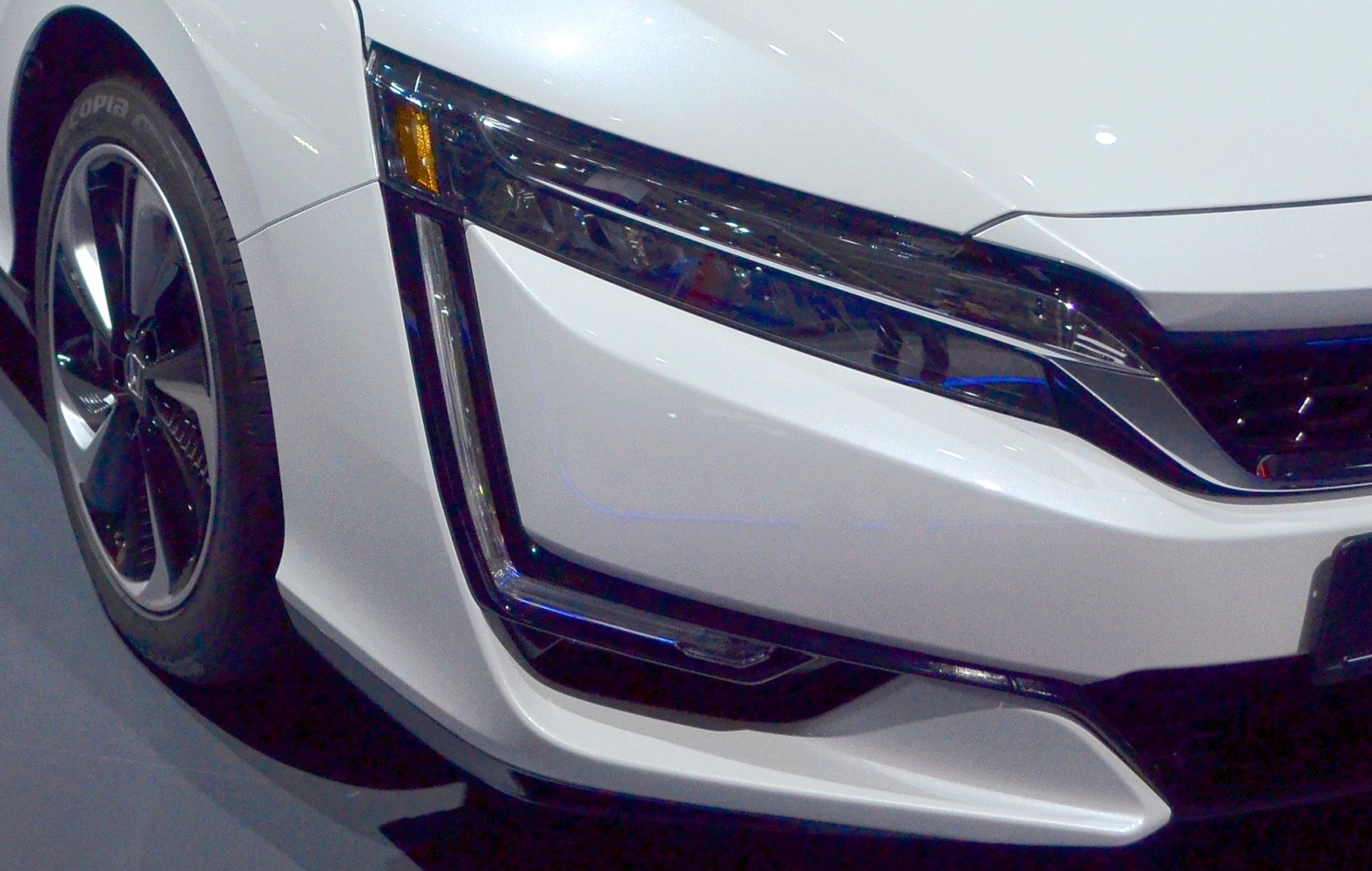 Close-up of front headlight and alloy wheel design