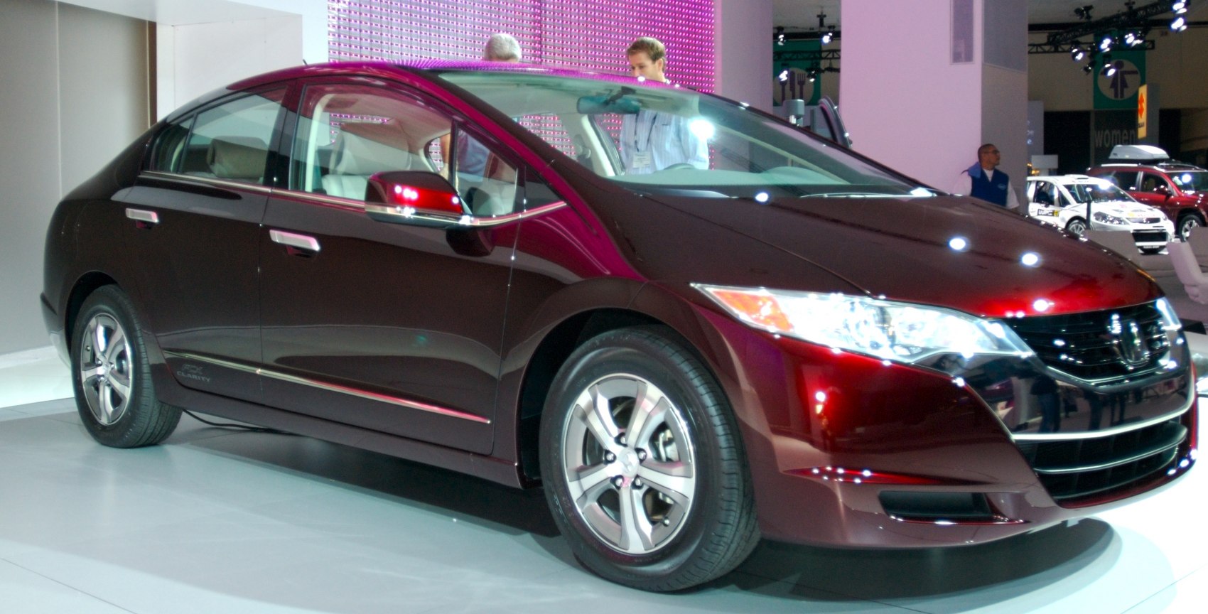 Front side exterior with sleek headlights and aerodynamic design