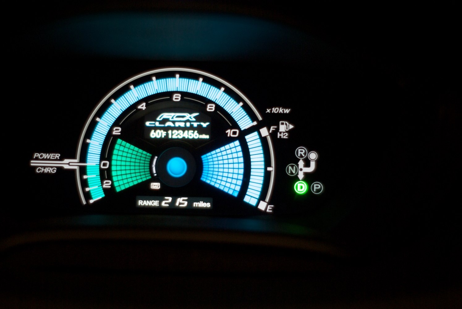 Illuminated digital instrument cluster with power and charge indicators, fuel gauge, gear selector lights