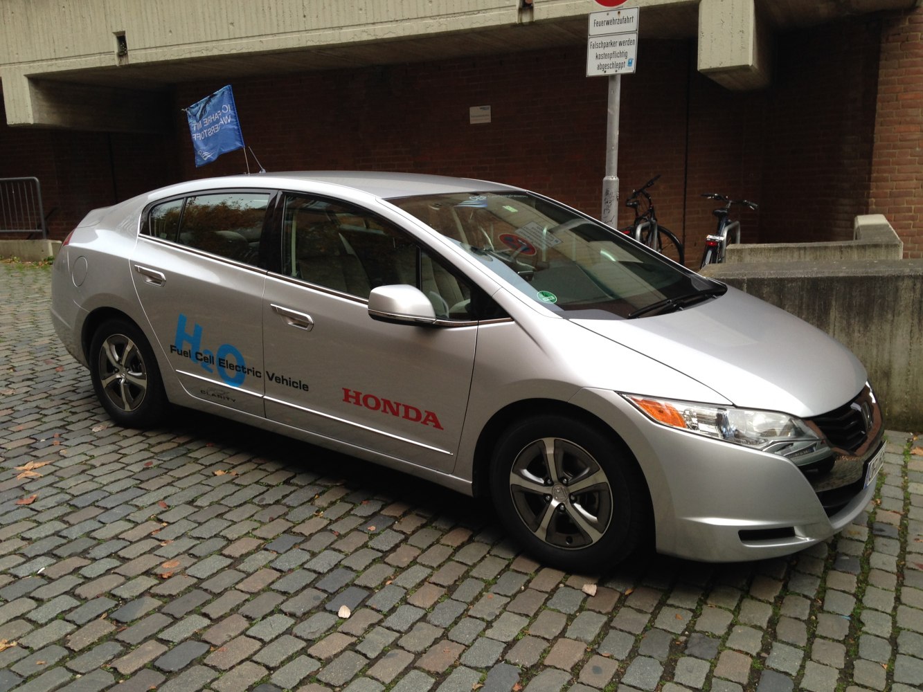 Silver fuel cell electric vehicle with aerodynamic design and sedan profile