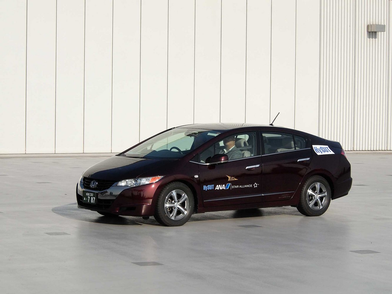Side profile of hydrogen fuel cell sedan with aerodynamic design and alloy wheels