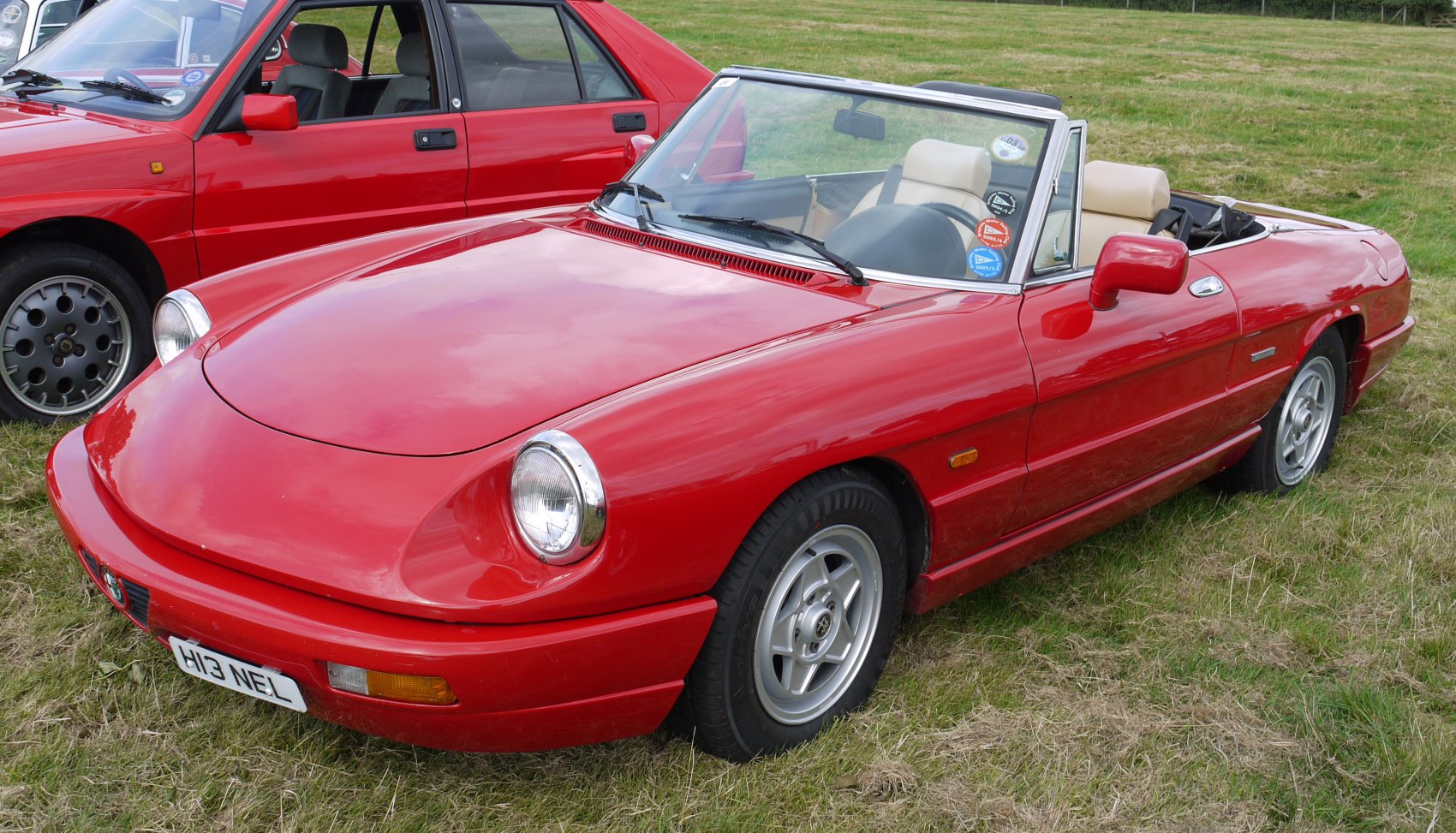 Red convertible with round headlights and sporty open-top design